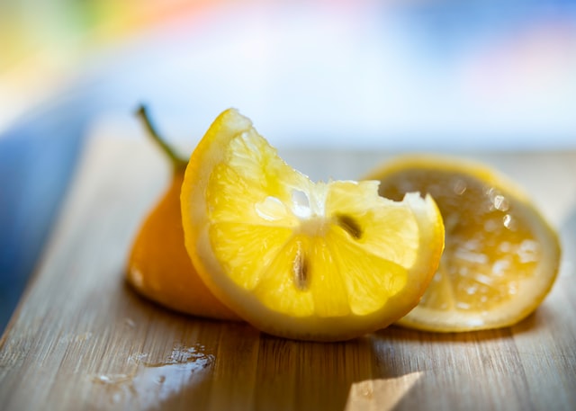 The sun shining through a lemon slice, showing it's seeds inside.