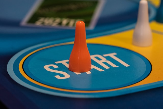 A plastic game piece on the starting point of a game board